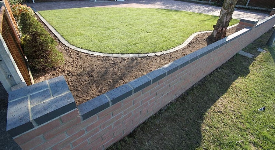 A low garden wall laid by Knights Paving and Landscaping