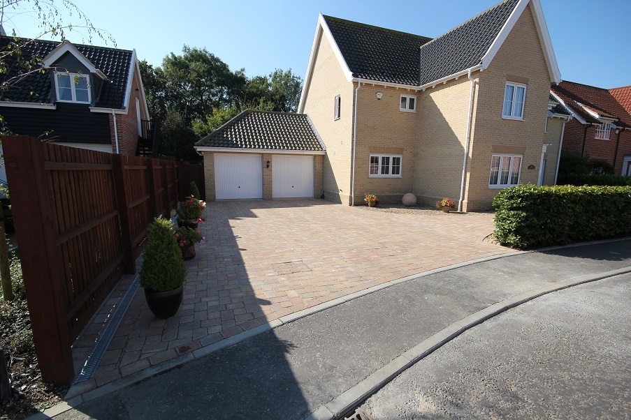 Paved driveway with small shingled garden