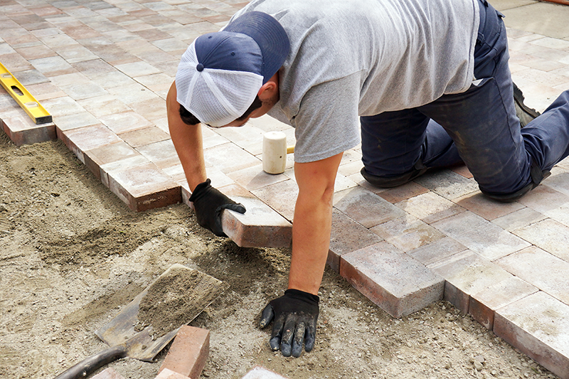 Landscaper laying paving